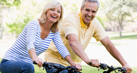 Happy retirees enjoying a bike ride